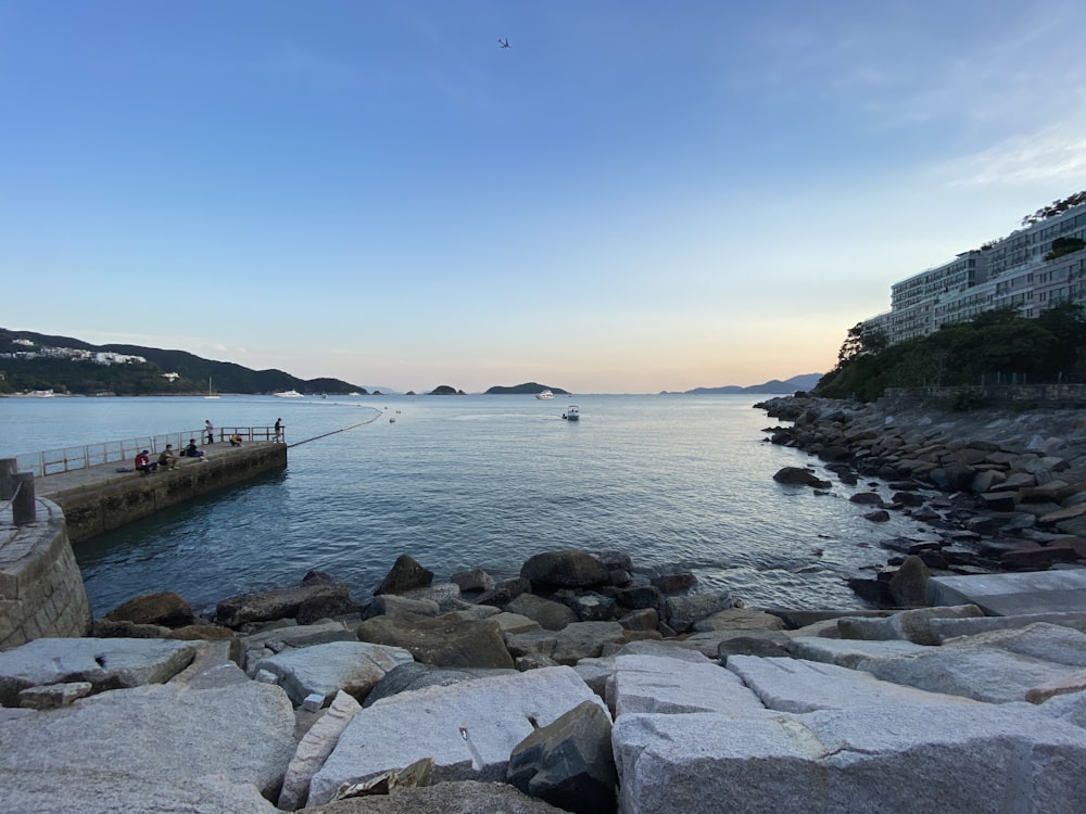 gray rocks on sea shore during daytime