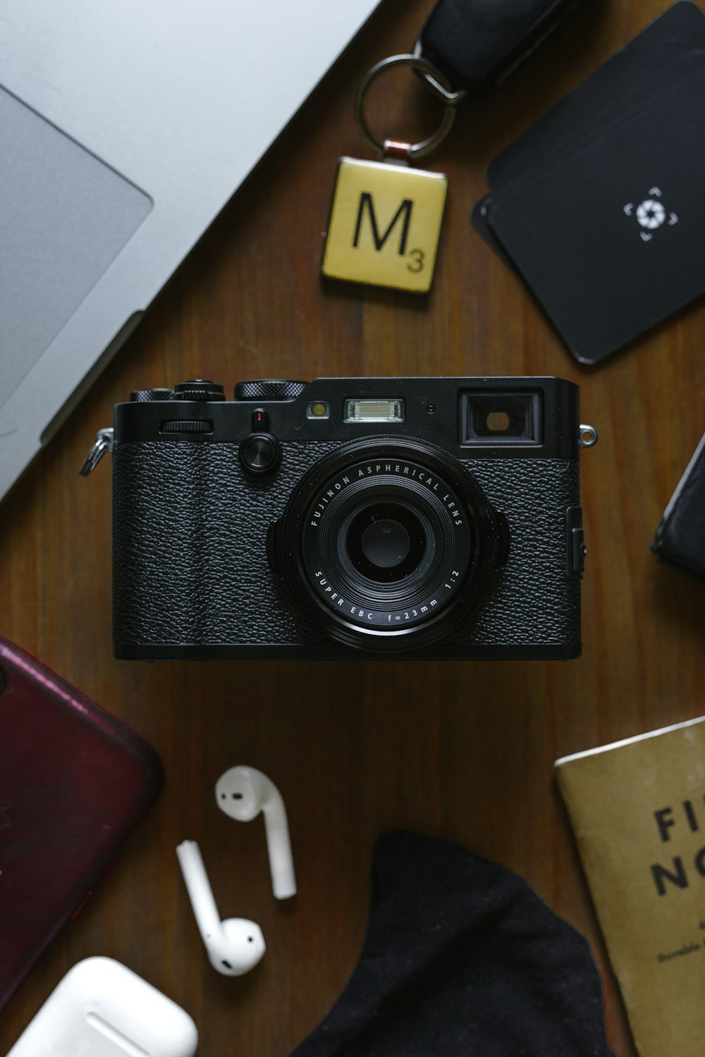 black and silver camera on brown wooden table