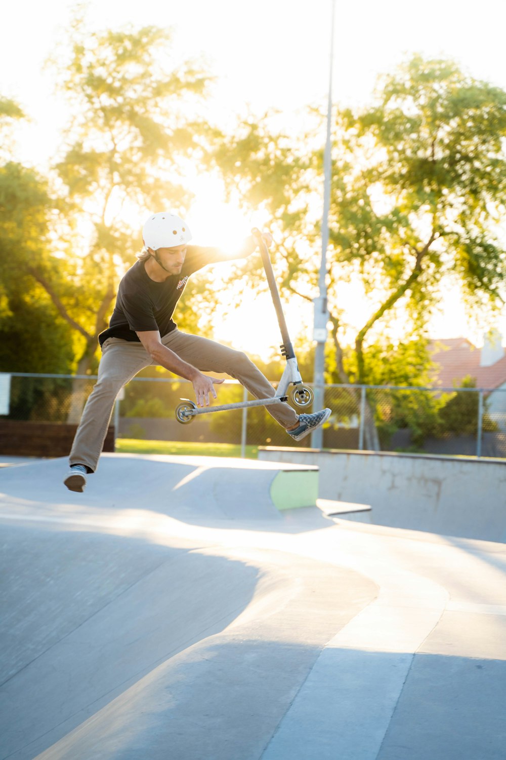 man in black t-shirt and black pants playing skateboard during daytime