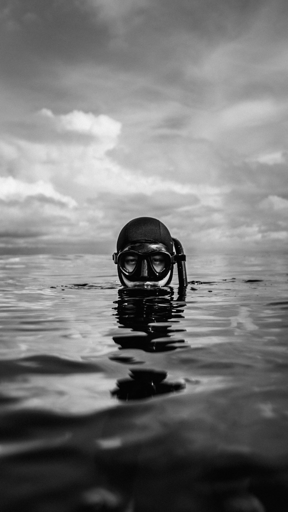 grayscale photo of person wearing goggles on water
