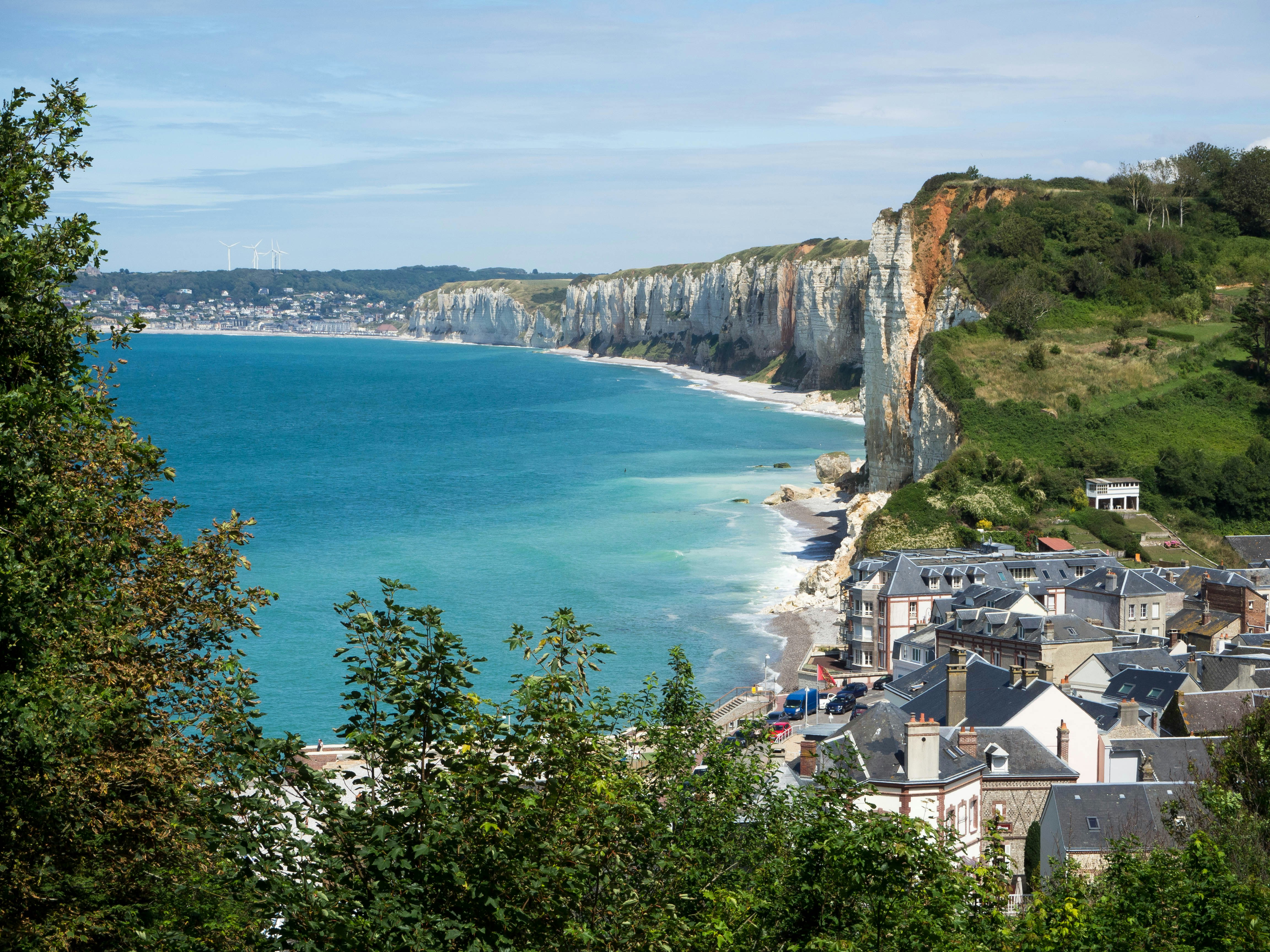 aerial view of houses on cliff by the sea during daytime