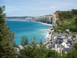 aerial view of houses on cliff by the sea during daytime