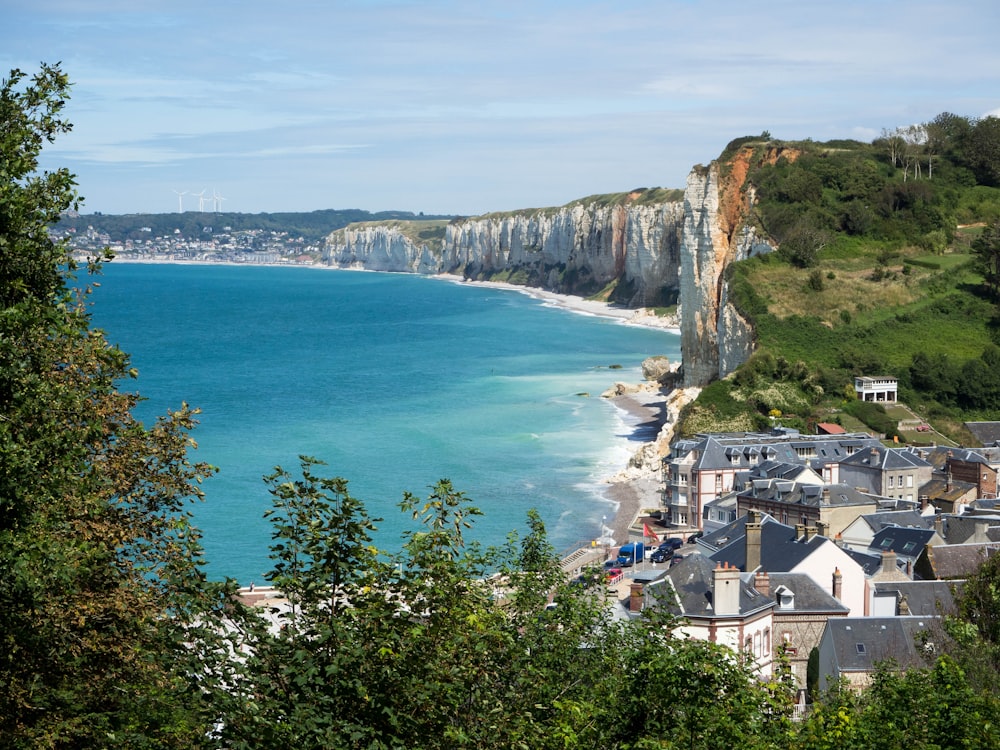 aerial view of houses on cliff by the sea during daytime