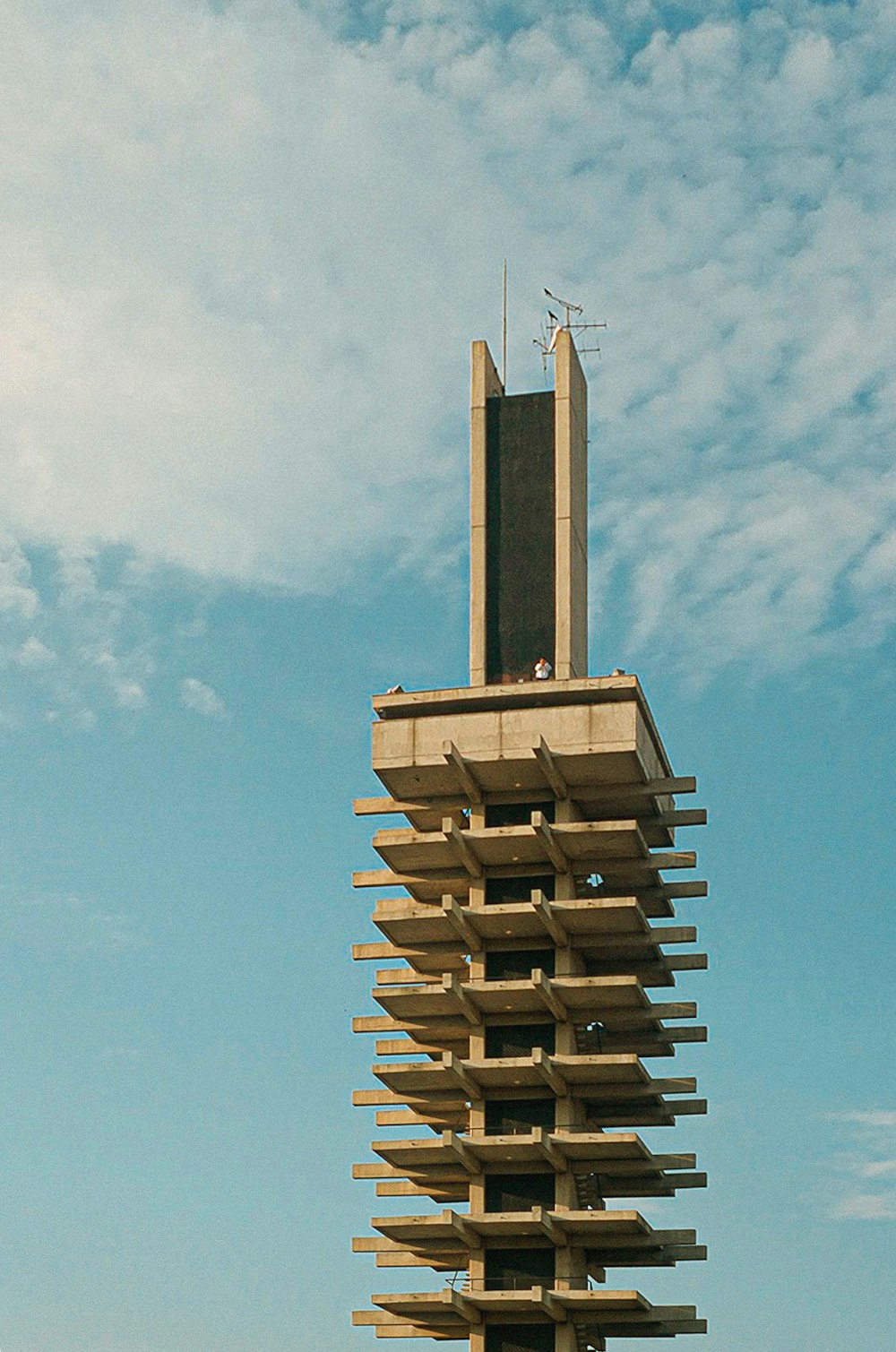 brown and gray concrete building under blue sky during daytime