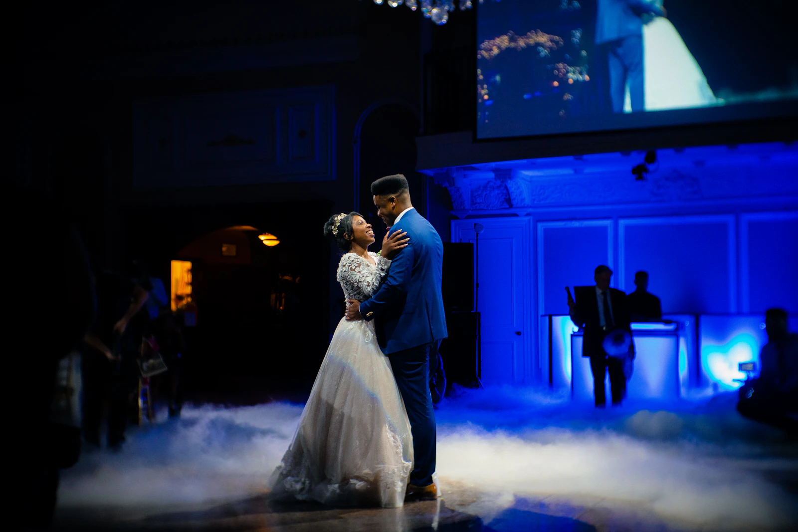 Bride and groom dancing together on stage at their reception