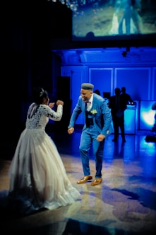 man in blue suit jacket and woman in white wedding dress