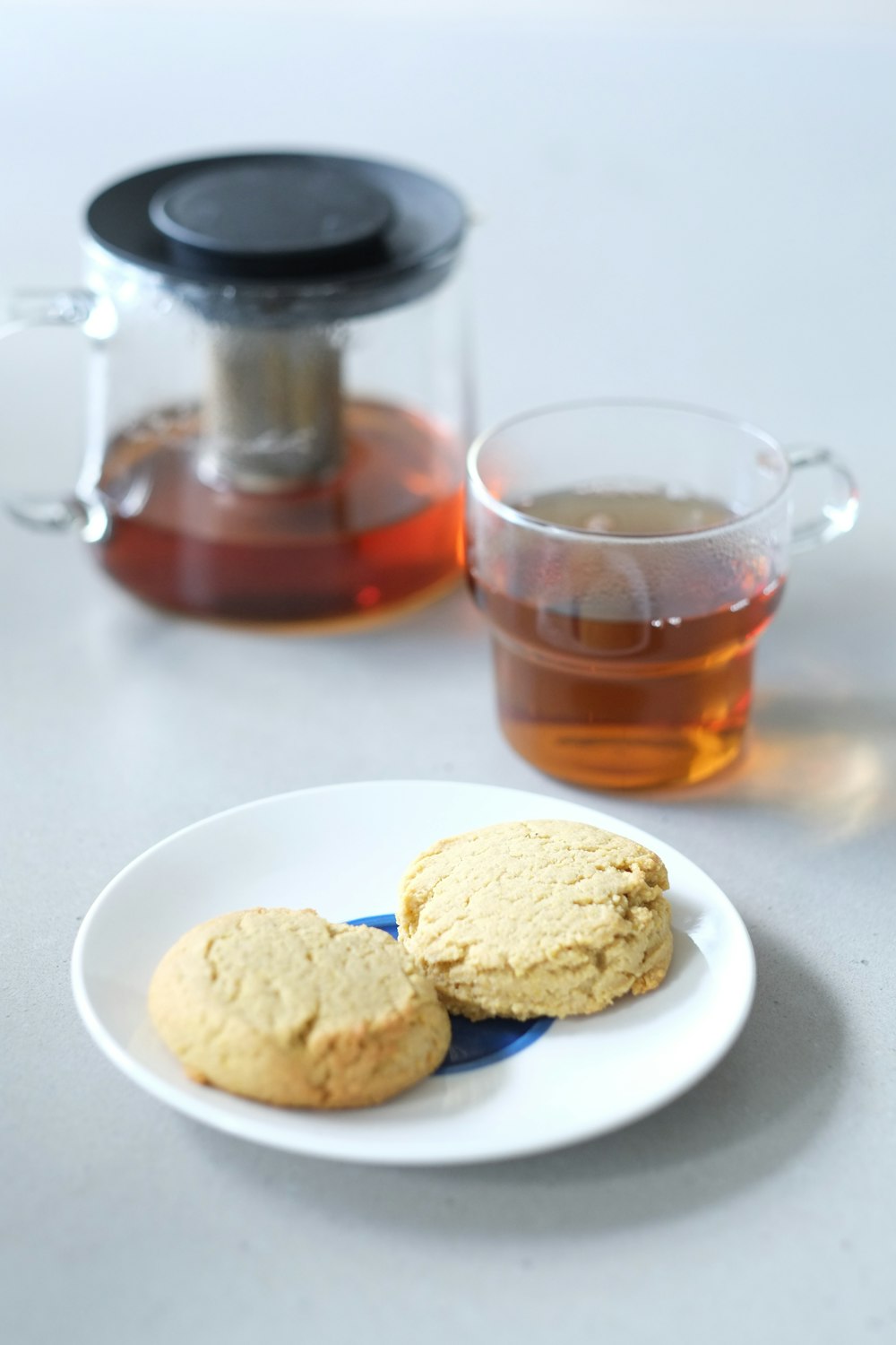 clear glass mug with brown liquid