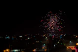 Colorful fireworks lighting up the night sky over a cityscape.