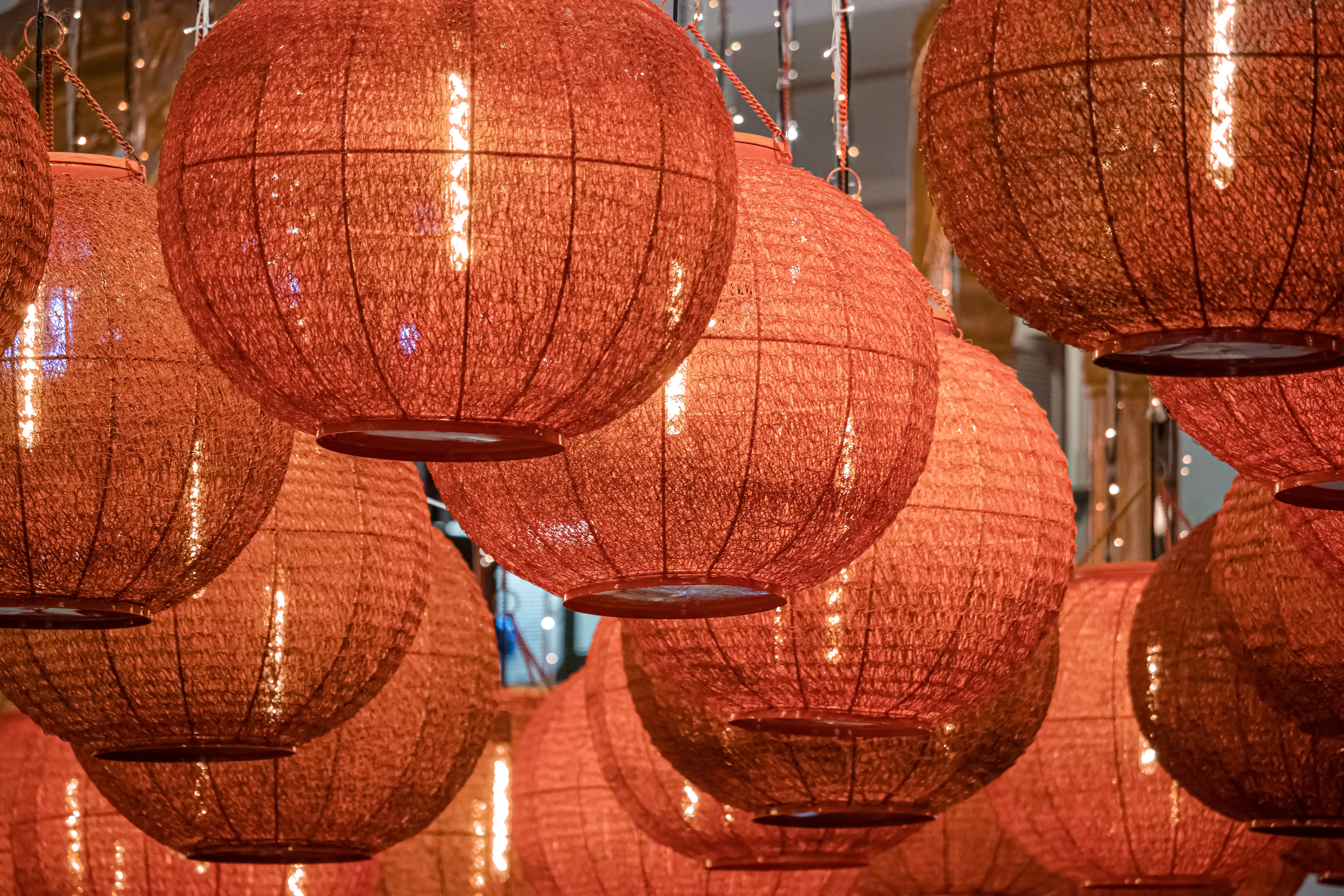 a bunch of red lanterns hanging from a ceiling