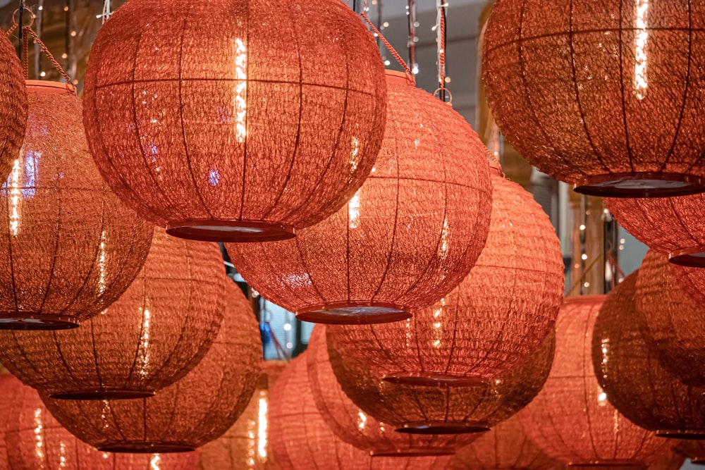 a bunch of red lanterns hanging from a ceiling