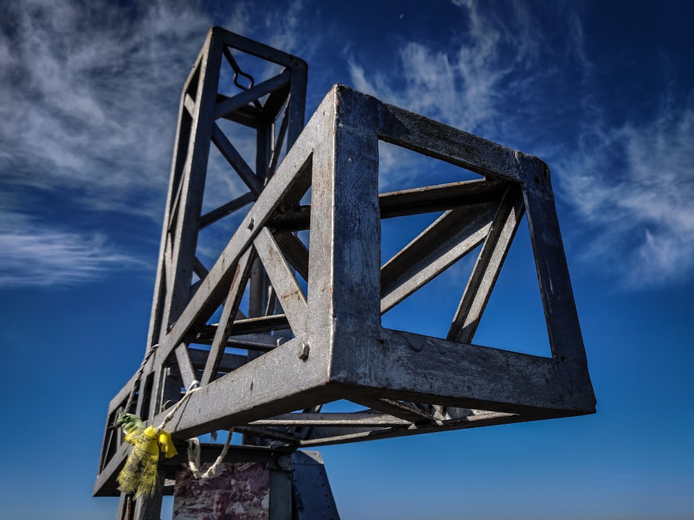 man in yellow shirt standing on gray metal ladder during daytime