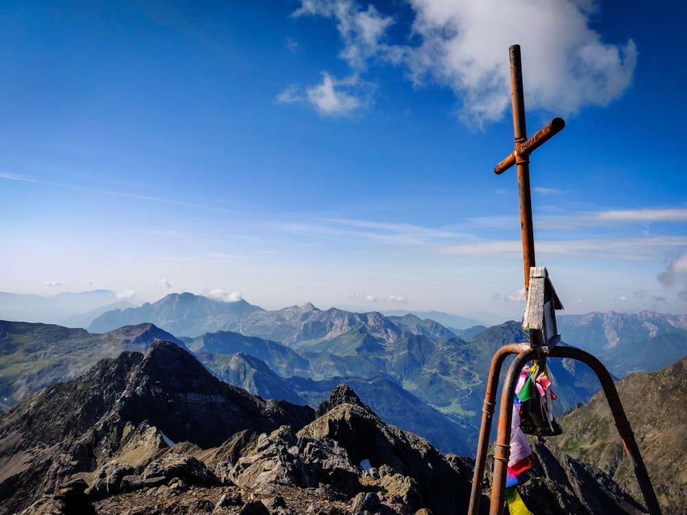 brown cross on top of mountain during daytime