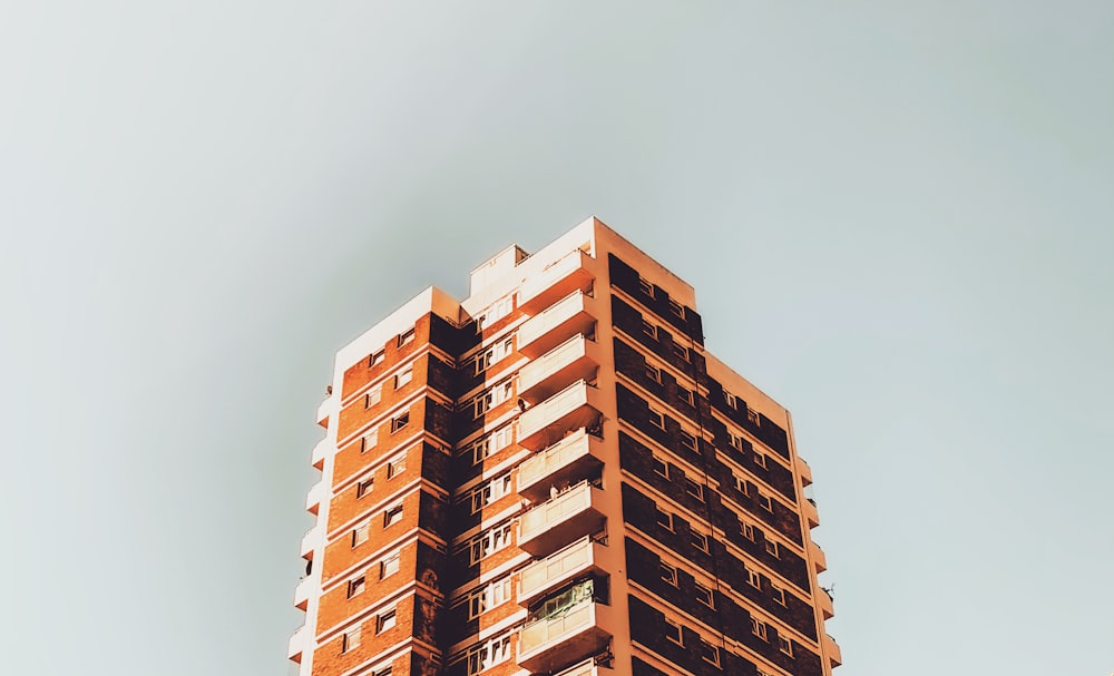 a tall building with balconies against a blue sky