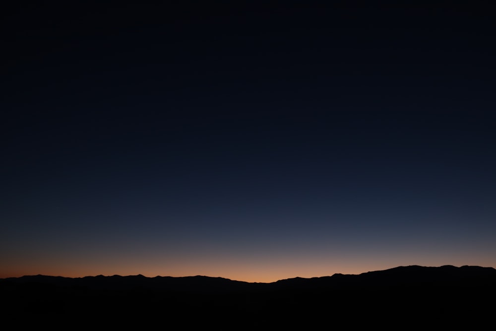 silhouette of mountain during sunset