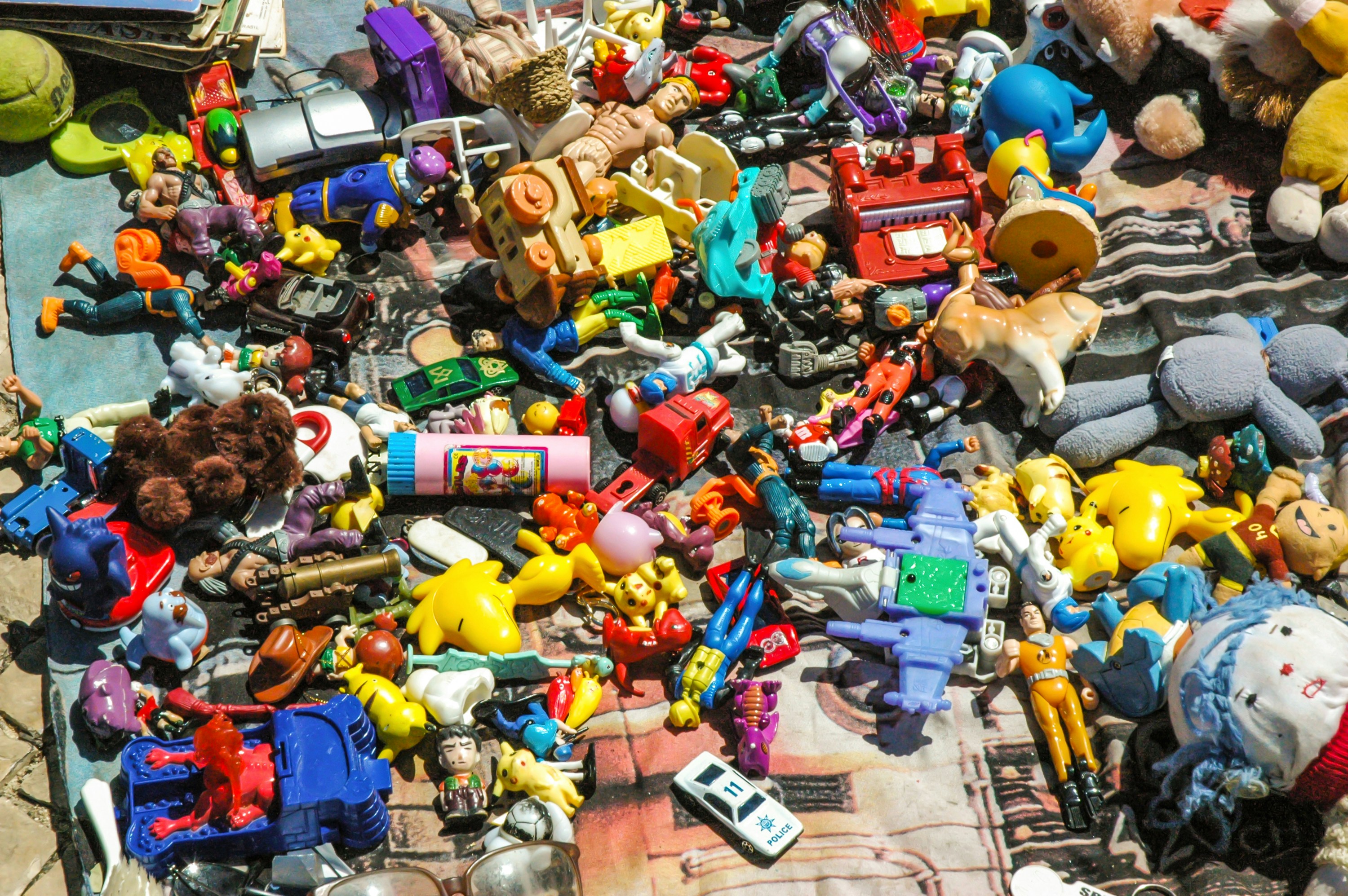 Sports equipment and colourful toys spread across a bright surface, energetic vibrant setting