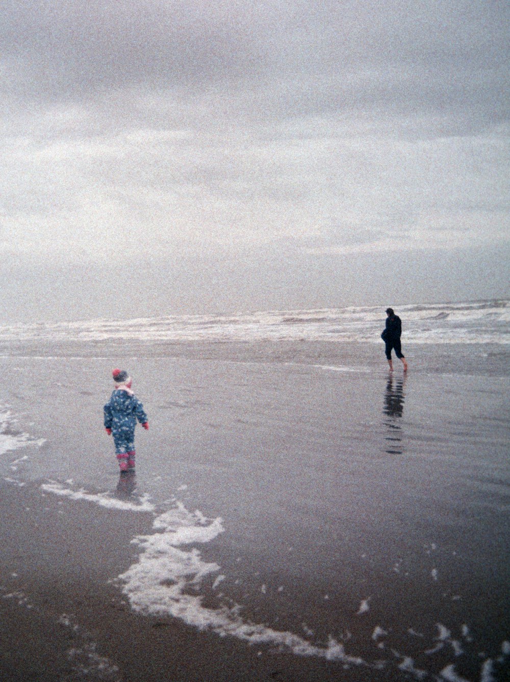 2 person walking on beach during daytime