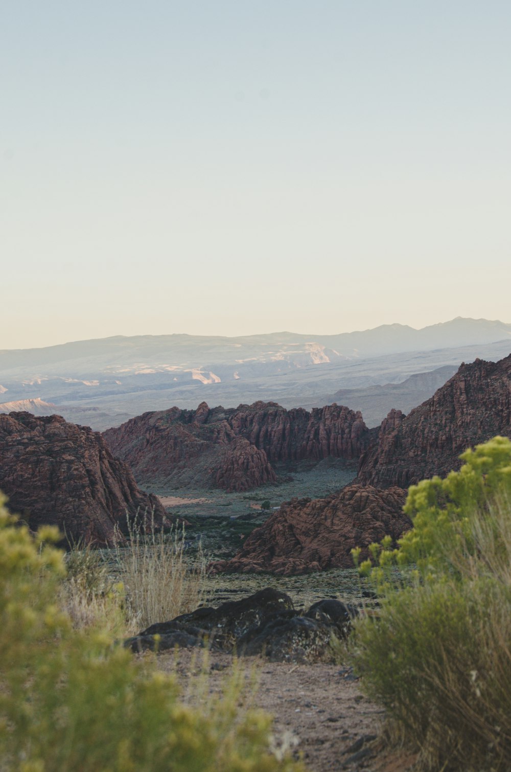 brown rocky mountain near body of water during daytime