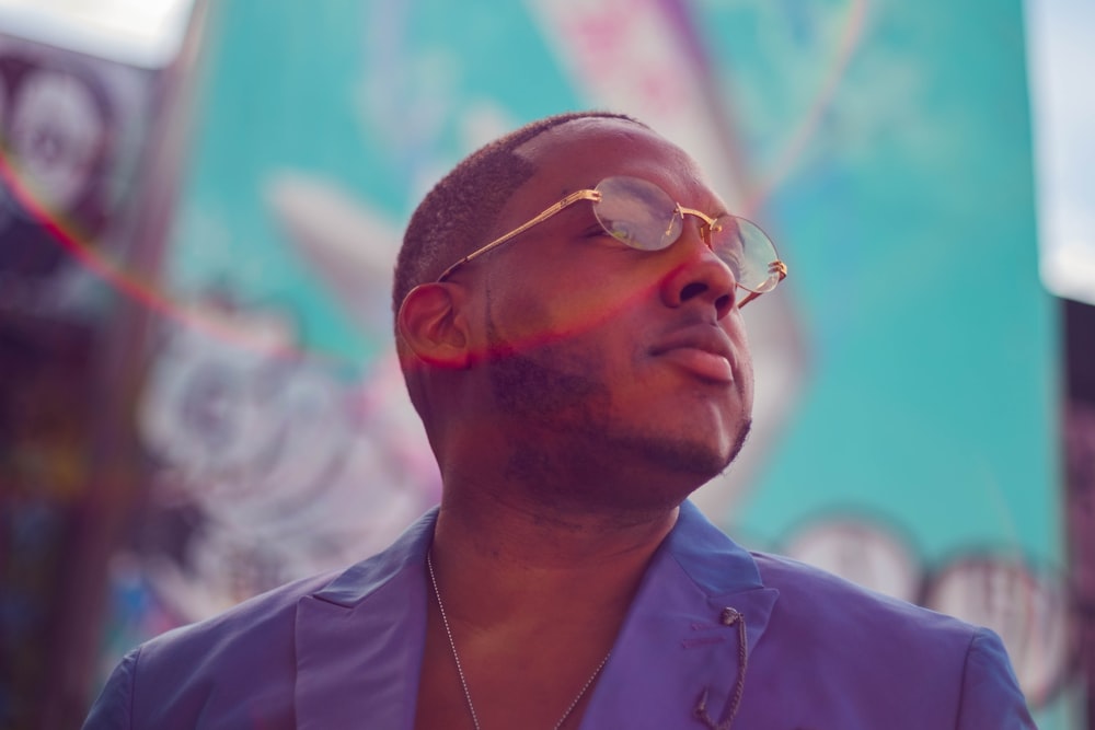 man in blue button up shirt wearing silver framed eyeglasses