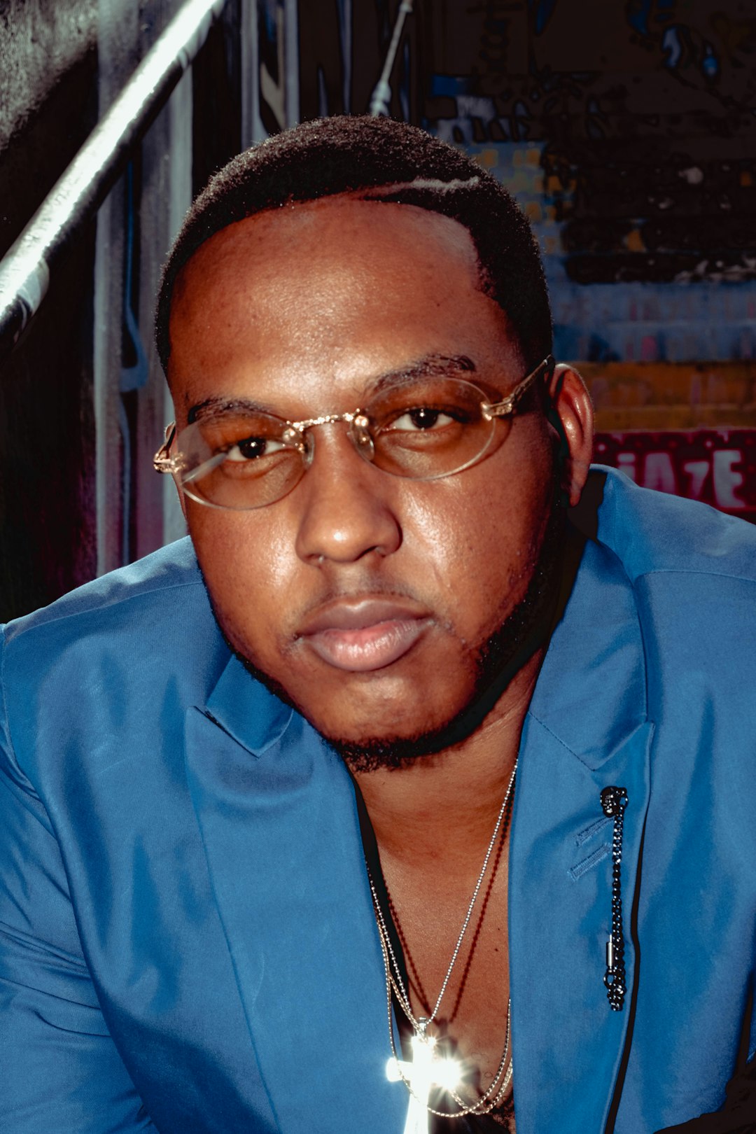 man in blue zip up jacket wearing eyeglasses
