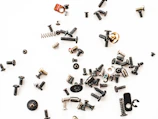 Colorful assortment of spare parts neatly arranged on a white background.