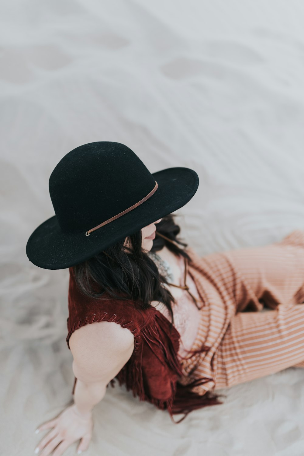 woman in black hat and red and white striped long sleeve shirt