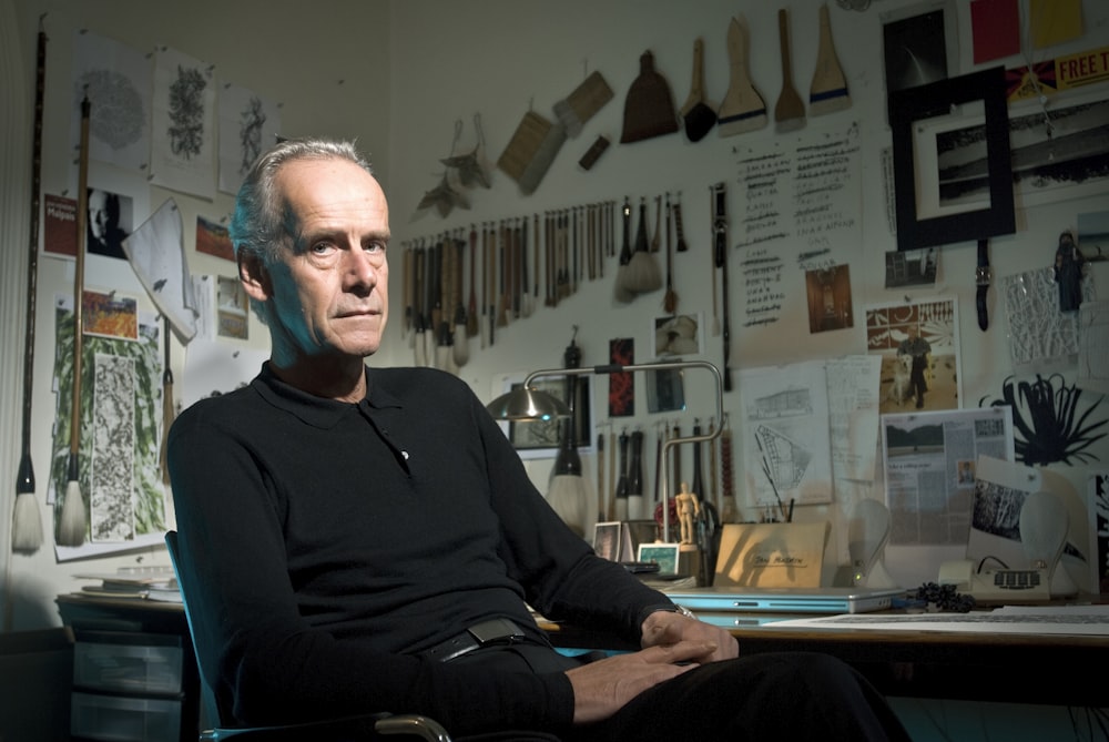 man in black long sleeve shirt sitting on chair