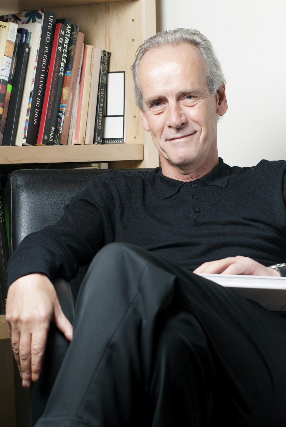 man in black long sleeve shirt sitting on black chair