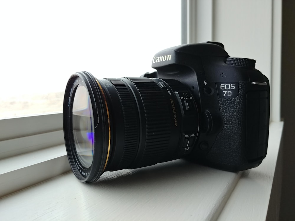 black nikon dslr camera on white table