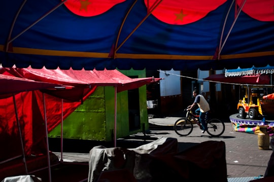 black bicycle parked near green canopy tent during daytime in Iztacalco Mexico