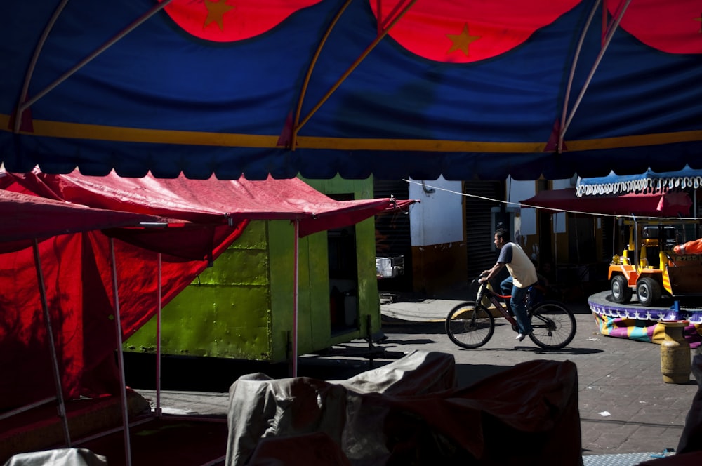 black bicycle parked near green canopy tent during daytime