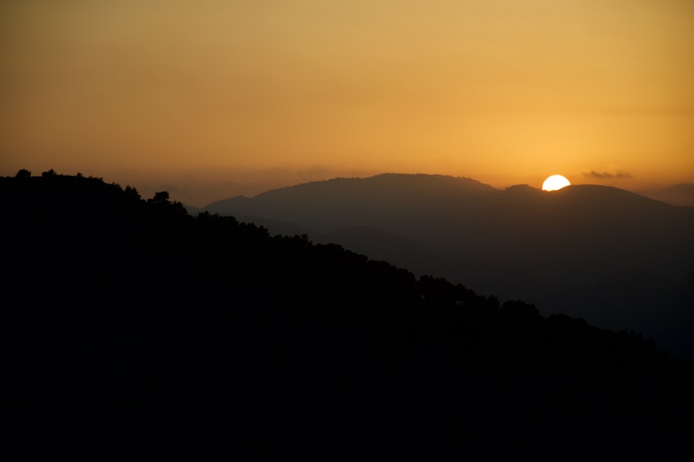 silhouette of mountain during sunset