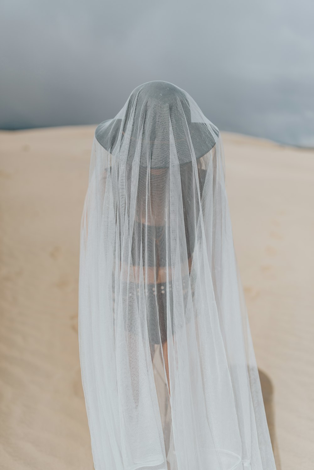 white sheer textile on brown sand