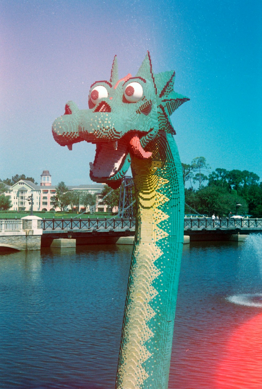 blue and yellow dragon statue near body of water during daytime