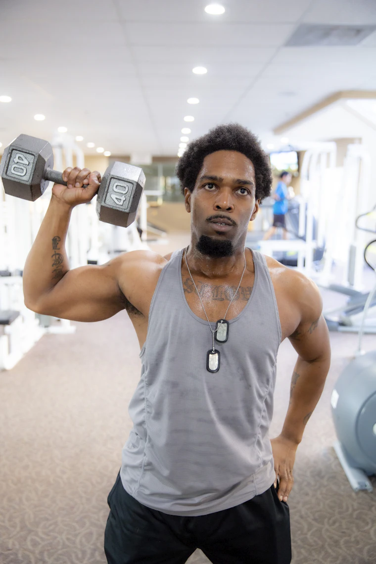 Andre Whitfield, head of strength, holding a dumbbell