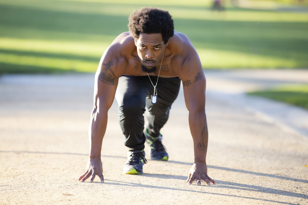 a man is doing push ups on a sidewalk