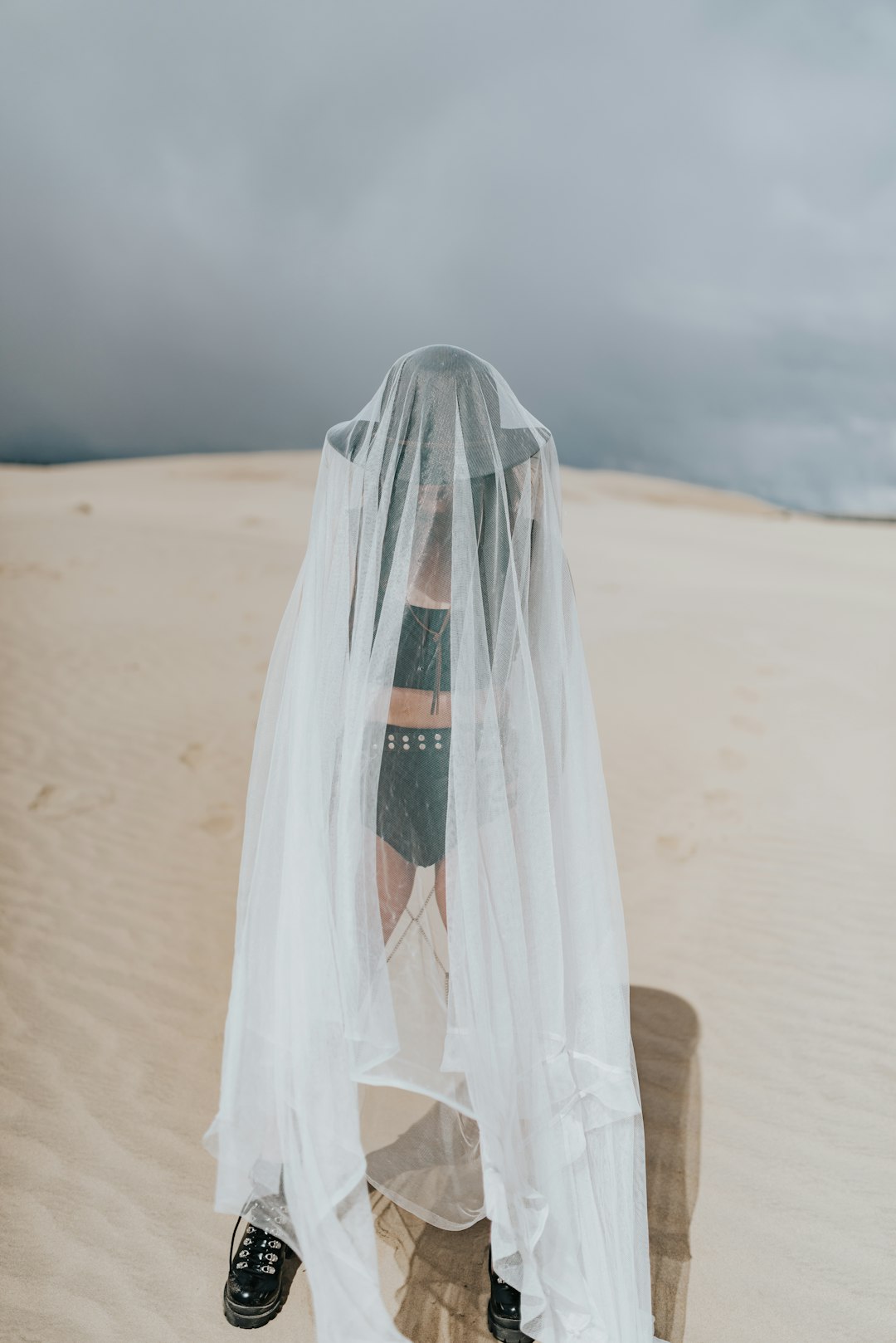 white and green textile on brown sand