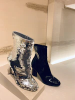 Stylish leather ankle boots displayed on a clean, neutral-toned backdrop