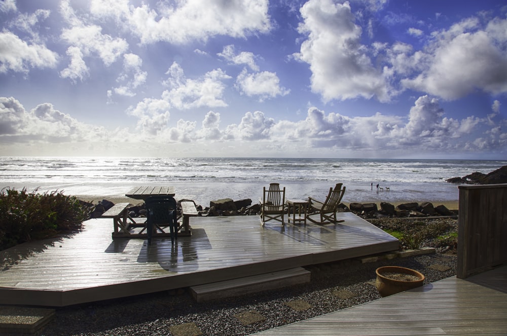 brown wooden table and chairs on beach during daytime