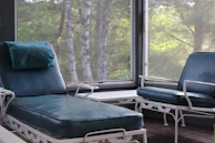 A cozy living room scene featuring a recliner with a vibrant blue cushion invitingly placed.