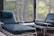 A serene living room with a massage chair positioned near a window, inviting relaxation.