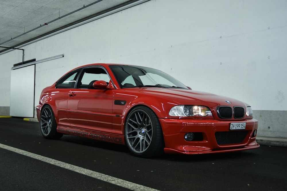 red bmw m 3 coupe parked on parking lot