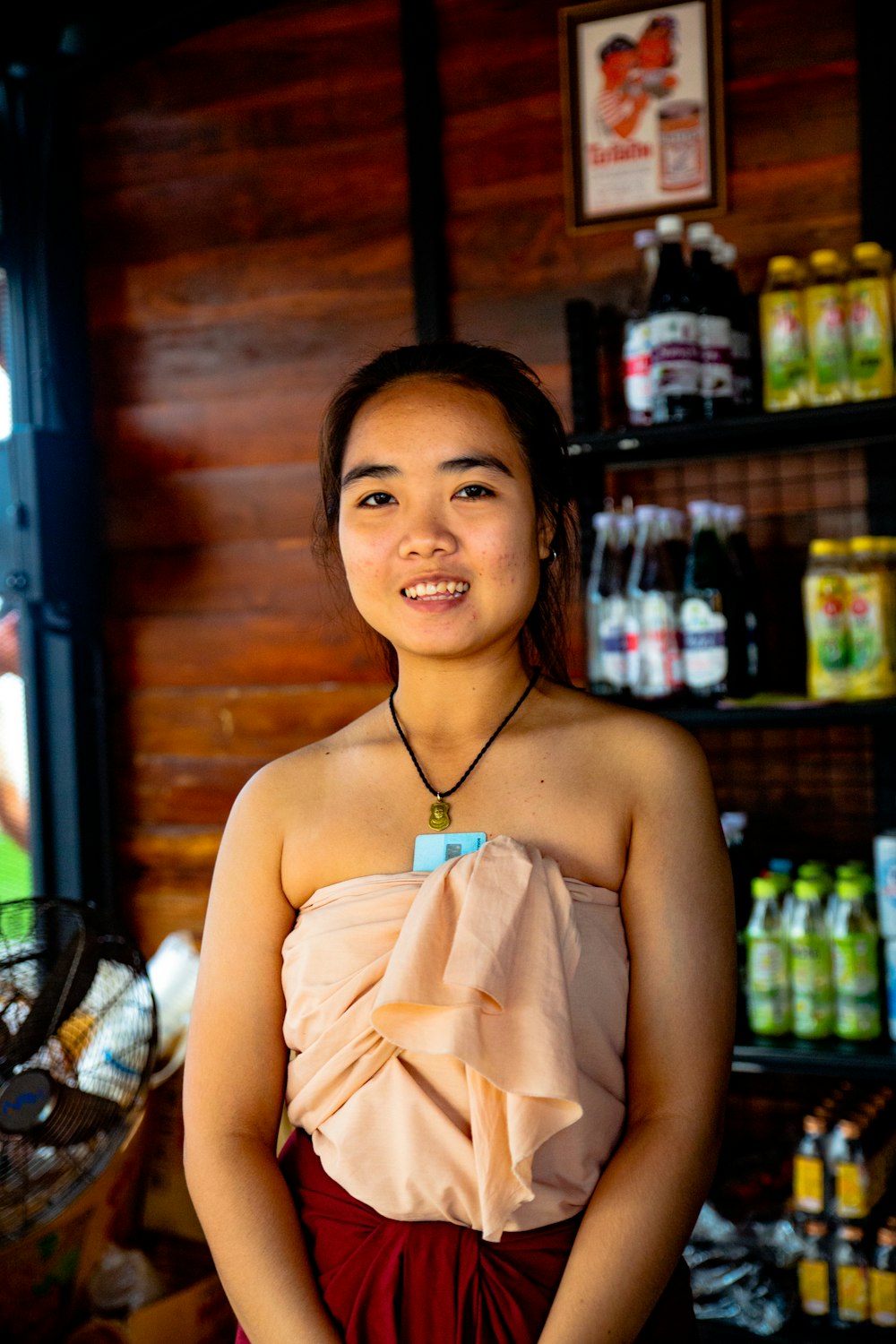 woman in white halter top smiling