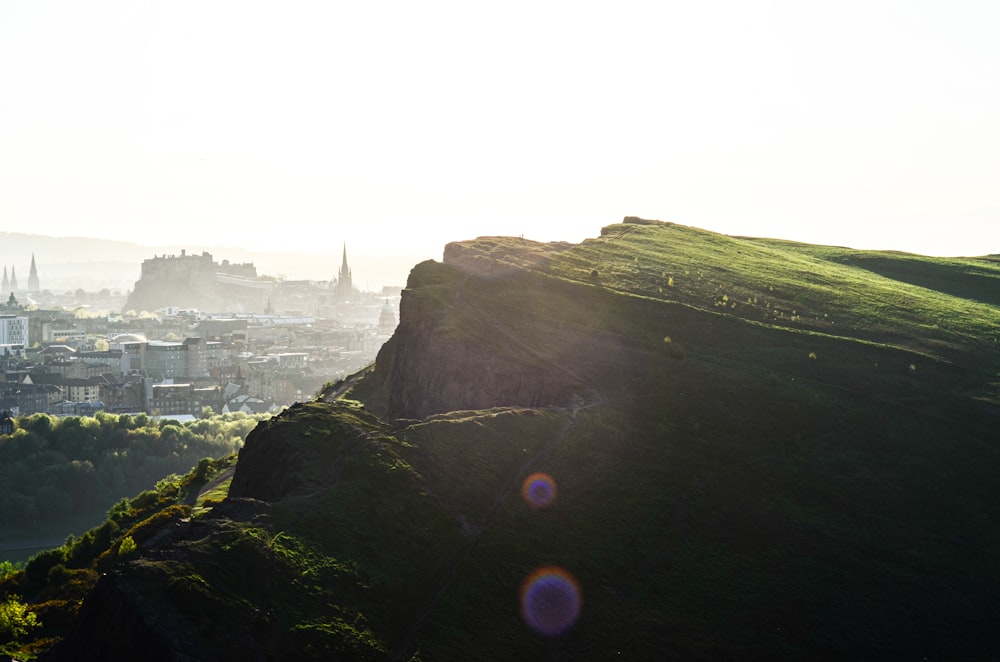 green grass covered mountain during daytime