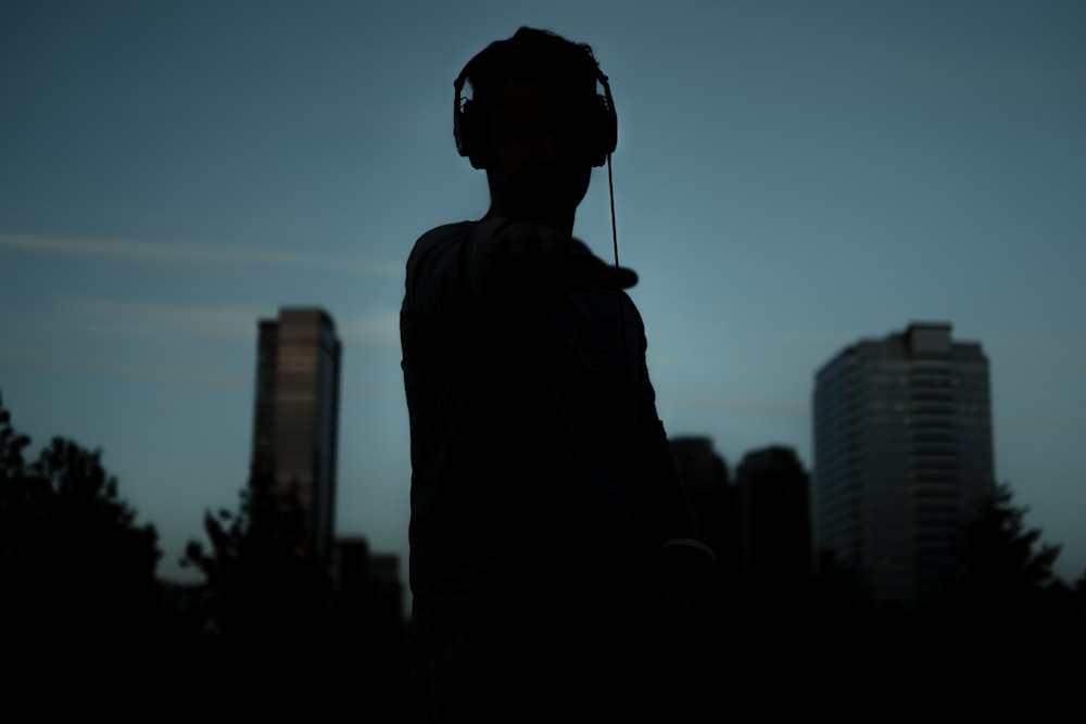silhouette of man wearing headphones