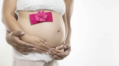 pregnant woman in white skirt