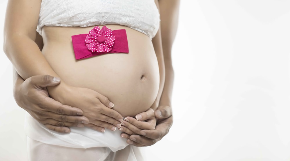 pregnant woman in white skirt