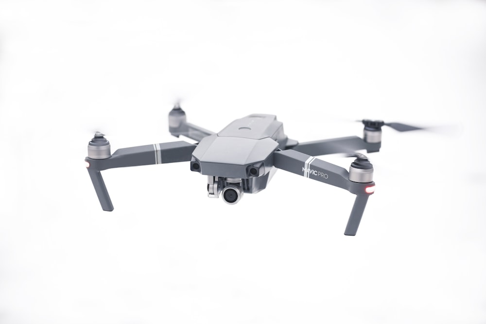 gray and black drone with white background