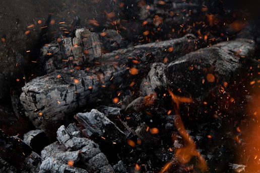 a close up of a pile of wood and fire