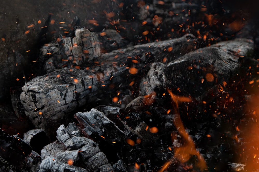 a close up of a pile of wood and fire