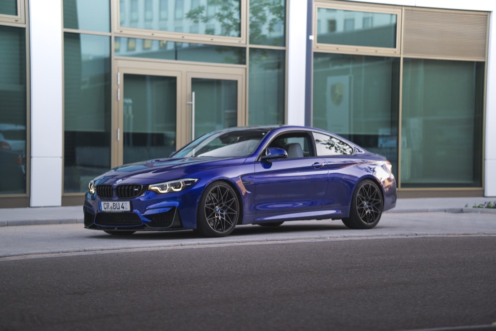 blue bmw m 3 coupe parked near white building during daytime